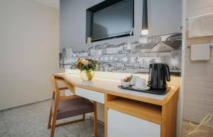 a kitchen with a desk with a coffee maker on it at Hotel Lero in Dubrovnik +46 photos