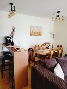 a living room with a couch and a table at Smilgose in Palanga