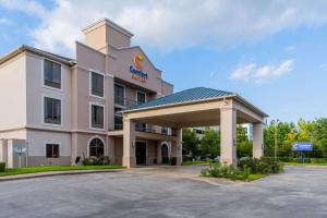 a hotel front of a building with a parking lot at Comfort Suites Houston West At Clay Road in Houston