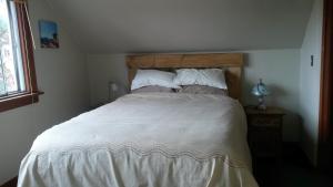a bedroom with a large bed with a wooden headboard at Bon Homme View in Jasper