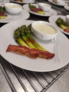 a plate of food with bacon and vegetables on it at L'HotenTyka in Saint-Senoch