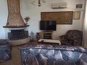 a living room with a fireplace and a tv at Apartment Dunka in Martinšćica