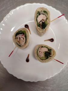 three wraps on a white plate with tooth picks at L'HotenTyka in Saint-Senoch