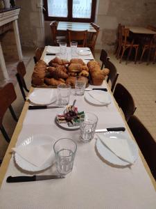 a long table with plates of food on it at L'HotenTyka in Saint-Senoch