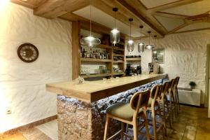 a bar with chairs and a counter in a room at Xenonas Iresioni in Arachova