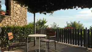 a table and two chairs sitting next to a fence at Antico Casale da Gemma - Fuscaldoapartment in Fuscaldo