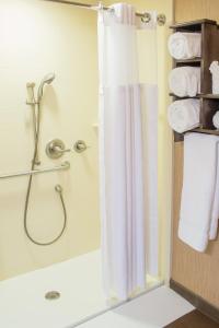 a bathroom with a shower and a shower curtain at Little Missouri Inn & Suites New Town in New Town