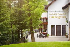 a park bench in front of a large building at Landhotel Lembergblick in Feilbingert