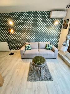 a living room with a couch and a table at Superbe Studio Balcon Emplacement nº1: Place Morny in Deauville