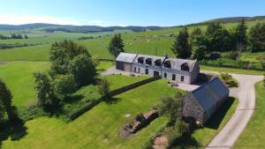 an aerial view of a house in a field at Moray Cottages in Dufftown