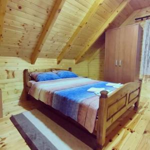 a bedroom with a bed in a log cabin at Mountain house Catherine in Žabljak