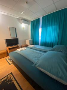Postel nebo postele na pokoji v ubytování Magnific Hotel