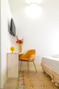 a bedroom with a desk and a chair next to a bed at Damasa Rooms in Lecce