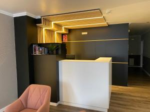 a lobby with a reception desk and a chair at Villa Alta in Villalba