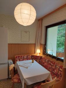 a room with a table and chairs and a large window at Bungalow Fritz in Presseggen