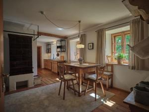 a living room with a table and chairs and a kitchen at Aigen 13 - Dreiviertelhof im Waldviertel in Aigen