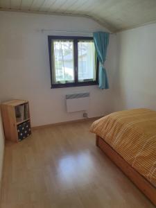 a bedroom with a bed and a window at Appartement Fully in Fully