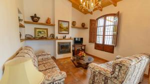 a living room with two couches and a fireplace at Casa El Mirador de Isabel Vélez-Málaga by Ruralidays in Vélez-Málaga