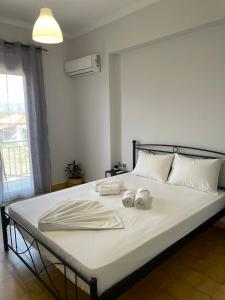 um quarto com uma cama com duas toalhas em Myrtilo Apartment em Ambelókipoi