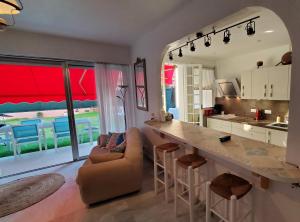 a kitchen with a bar and a living room at Superbe Rez de Jardin dans résidence au calme in Nice