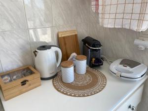 a counter top with a blender and cups on it at Noufaro rooftop-sea view apartment in Zipárion