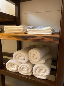 a bunch of towels on a shelf in a bathroom at apartma MAKS in Podbela