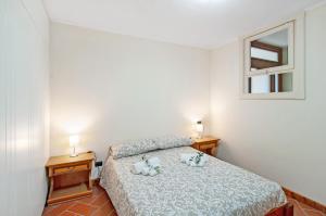 a bedroom with a bed with two stuffed animals on it at Il Casale di Marnino in Cremia