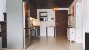 a kitchen with a stainless steel refrigerator in a room at Can Lasai in Barruera