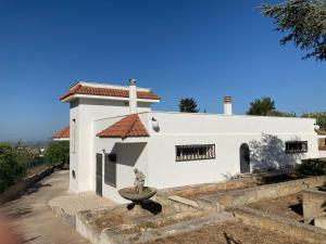 a white building with a statue in front of it at Villa Paci sulle colline salentine in Parabita