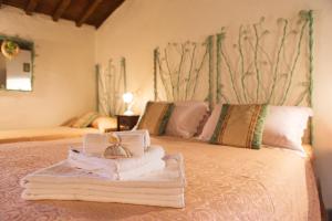 a bedroom with two beds with towels on the bed at Poggio al Sole in Fiesole