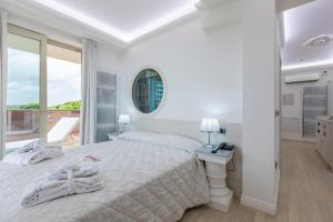 Postel nebo postele na pokoji v ubytování Boutique Hotel Paradiso Bovelacci