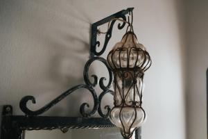 a metal chandelier hanging over a mirror at Alf Leila Boutique Hotel in Dahab