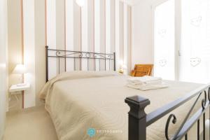 1 dormitorio con 1 cama grande y paredes a rayas en Romina's Flat, en Porto Cesareo