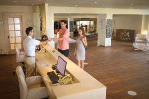 a group of people standing in a lobby at Yacht Club in Didim