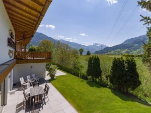 a patio with a view of a garden and mountains at Apart Stiegler in Stumm