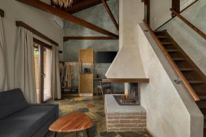 a living room with a fireplace and a staircase at Agramada in Arnaia