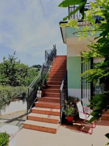 a staircase leading up to a house with two chairs at Vivi Conero in Ancona