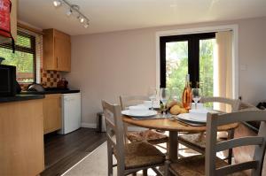 a kitchen and dining room with a table and chairs at Piper's Lodge in Coirantee