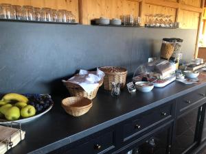 a counter with bowls of fruit and baskets on it at Pension „Alte Straßenmeisterei „ in Hasselfelde