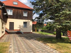 a house with a brick driveway in front of it at Pension „Alte Straßenmeisterei „ in Hasselfelde