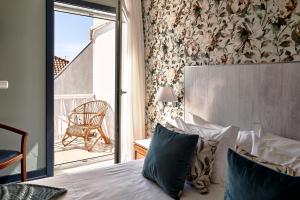 Postel nebo postele na pokoji v ubytování Galeria Suite Hotel
