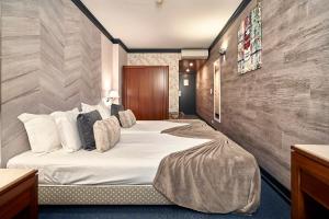 Postel nebo postele na pokoji v ubytování Galeria Suite Hotel