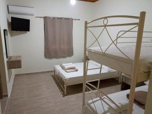 a small room with a bunk bed and a table at palm-tree in Arkoudi