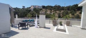 a patio with a bench and a view of a building at AleVa b&b in Vieste