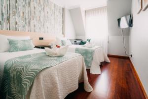 Cama o camas de una habitación en PENSIÓN CALDEA