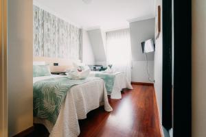 Cama o camas de una habitación en PENSIÓN CALDEA