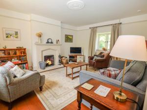 a living room with two couches and a fireplace at No 1 Eastington in Cheltenham