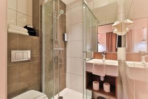 a bathroom with a shower and a toilet and a sink at Hôtel Cyano Fréjus-Saint Raphaël in Fréjus +205 photos
