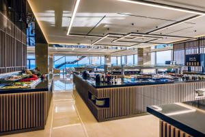 a restaurant with a buffet line in a building at Ammoa Luxury Hotel & Spa Resort in Nikiti