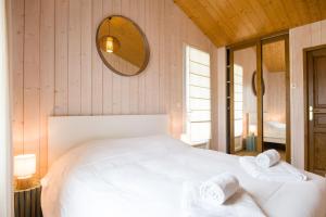 a bedroom with a white bed and a mirror at "MORANDE" grande maison avec Piscine Chauffée in La Noue +14 photos